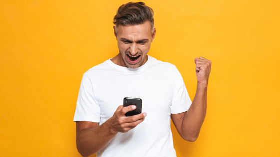 Man cheering after winning on Dragon Hatch 2 pg slot game